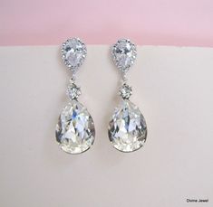 "These glamorous earrings have clear Swarovski teardrop crystal and cubic zirconia studs. Post are .925 sterling silver over brass. Earrings are approximately 1 1/2\" long from top to bottom. Swarovski teardrop crystal measures 18 x 13 mm. They make a great complement for your wedding gown or special occasion attire! Coordinating necklaces, https://www.etsy.com/listing/90471789/bridal-necklace-swarovski-crystal-bridal?ga_search_query=aria https://www.etsy.com/listing/118579885/bridal-necklace-sw Bridal Chandelier Earrings, Glamorous Earrings, Long Crystal Earrings, Crystal Cluster Earrings, Long Bridal Earrings, Bridal Earrings Studs, Pearl Drop Earrings Gold, Natural Pearl Earrings, Bridal Earrings Chandelier