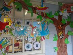 a classroom decorated with colorful paper cutouts and trees