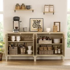 an open shelf with coffee cups and other items on it