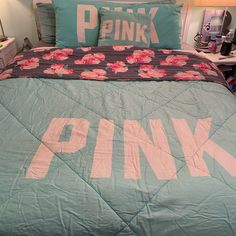 a bed with pink letters on it in a bedroom next to a night stand and lamp