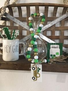 a wooden shelf topped with green and white items next to a basket filled with st patrick's day decorations