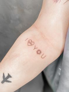 a person with a tattoo on their arm that says i love you and an airplane