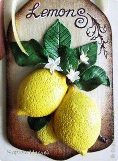 two lemons with leaves and flowers on a wooden plaque that says lemon's