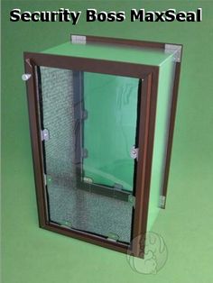 a green box with some glass in it on a green surface and the door is open