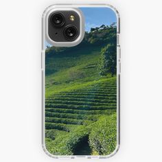 an iphone case with the image of a tea plantation on a hill in the background