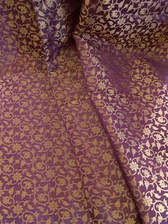 This listing is for 1 yard of beautiful purple golden brocade silk. Fabric Width: 42-43” wideFabric Type: Semi Silk BrocadeThroughout history, brocade was a fabric of luxury worn by nobility in various cultures, from India to Korea. Brocade is a heavy fabric similar to jacquard with a raised pattern or floral design. Traditionally the pattern was produced with gold or silver thread said to be of such superb quality that they could be woven into the fabric of gold and silver. Gold Jacquard Fabric In Traditional Style, Elegant Brocade Dupatta With Woven Motifs, Traditional Festive Jacquard Fabric, Gold Brocade Dupatta With Woven Motifs, Traditional Gold Brocade Fabric, Elegant Gold Traditional Wear With Woven Motifs, Festive Brocade Fabric With Zari Weaving, Elegant Brocade Saree With Woven Motifs, Brocade Fabric With Zari Weaving For Festivals