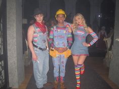 three people dressed in costumes posing for the camera