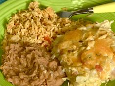 a white plate topped with rice and meat on top of a red checkered table cloth