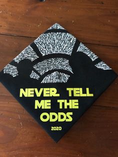 a graduation cap that says never tell me the odds