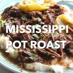 a blue plate topped with mashed potatoes and meat