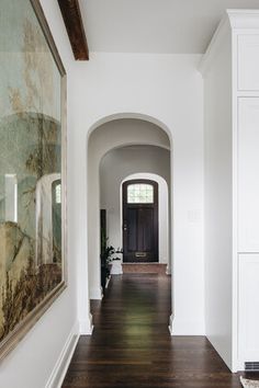 the hallway is clean and ready to be used as an entrance way for someone's home