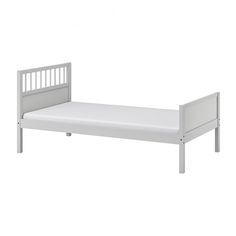 a white bed frame with no sheets on it