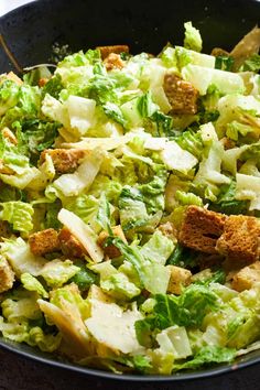 a salad with lettuce and croutons in a skillet