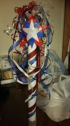 a red, white and blue pole decorated with streamers