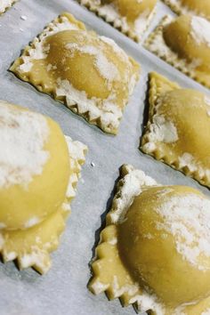 several pastries covered in powdered sugar on a baking sheet