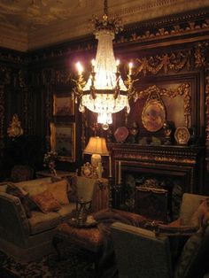 an ornate living room with chandelier and couches