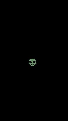 an alien head is seen in the dark