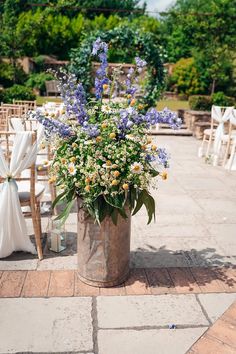 an outdoor ceremony setup with chairs and flowers