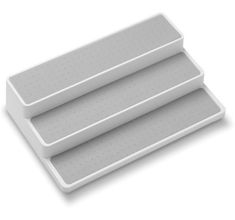 three white plastic trays with holes on them