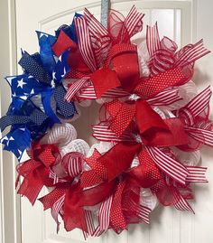 a red, white and blue wreath on a door