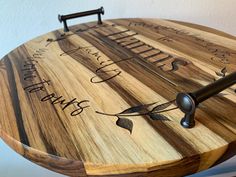 a wooden clock that has writing on it