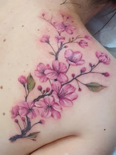 a woman's breast with pink flowers on it