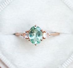 an aqua and white diamond ring with three stones