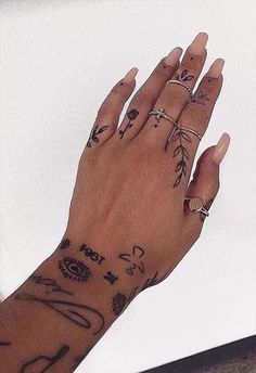 a woman's hand with tattoos on it