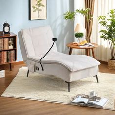 a white chaise lounge chair sitting on top of a rug