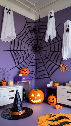 a room decorated for halloween with pumpkins and ghost decorations