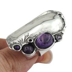 Sculptural sterling silver Unique and Bold, Statement Purple Amethyst Ring This is a very unique, outstanding ring, Fits for Men and Women All items are 100% made in Israel Labeled and stamp We will send this jewelry in a gift box. Available in many other gemstones, if you wish a different option, please write to us. SHIPPING INFORMATION: Registered and insured shipping will arrive safely to you. We take no responsibility for possible customs fees or taxes that your respective countries may impo Purple Stone Rings, Antique Engagement Ring, Purple Amethyst Ring, Purple Rings, Bold Rings, Big Rings, Unisex Ring, Purple Stones, Silver Rings Handmade