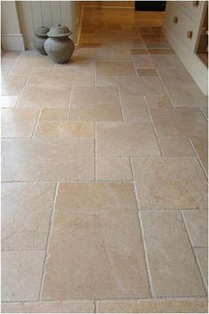 a kitchen floor with two vases on it