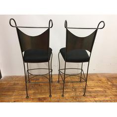 pair of black mesh and metal chairs on casteors, circa to mid 20th century