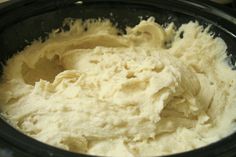 a black bowl filled with batter on top of a table