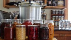 jars filled with food sitting on top of a wooden counter