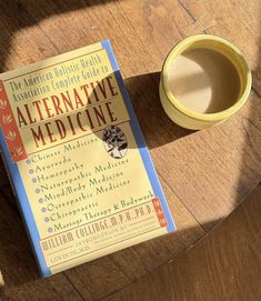 an alternative medicine book next to a coffee cup