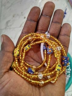 "Thank you for your interest in purchasing Bulk/wholesale Waist Beads. Please Note: **These Waist beads Ship from Ghana, West African. They are traditional and authentic yet Fancy and fashionable.* ** Shipping takes 3-5 days to be delivered* ** I will send you nice selection of the beads unless you want to make your own choices, then you can email me to send You individual pictures of he waist beads #Waist beads sizes Varies from 35\"- 45\" # They are all made with cotton threads # Bead sizes va Traditional Beaded Bracelets With Tiny Round Beads, Traditional Orange Beaded Bracelets With Polished Beads, Traditional Yellow Beaded Bracelets For Festival, Traditional Handmade Beaded Bracelets With Oval Beads, Traditional Yellow Bracelets With Round Beads, Artisan Yellow Beads For Festivals, Festive Colorful Beaded Bracelets, Festive Colorful Beads Bracelet, Traditional Yellow Beaded Necklaces With Polished Beads