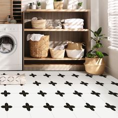 a washer and dryer in a room with black and white tile flooring