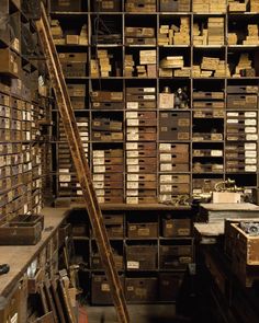 a large room filled with lots of boxes and shelves full of items on top of each other