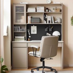 an office chair sitting in front of a desk with bookshelf and shelves above it