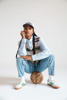 a woman sitting on top of a ball while holding a cell phone to her ear