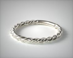 a silver rope ring on a white background