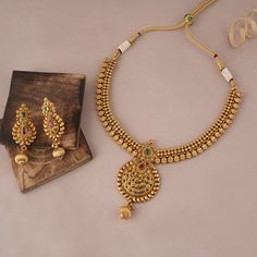 Royal antique gold plated necklace set for women is made of brass alloy with gold plating. The necklace length is 22 inches, and the necklace lock is Drawing String The earrings are 2  inch long, and its lock is a push-back. This set comes with beautiful pair of matching earring  Royal antique gold plated necklace set for women is a show-stopping, traditional Indian necklace set with gold plating and handwork.   NOTE:  Royal anitque gold plated necklace set for women for women is has been crafted by hand and may have slight irregularities or imperfections in color or embellishment. These irregularities are the result of human involvement in the process and add to the finished product's charm while ensuring you have a one-of-a-kind piece. Gold Short Set, Necklace And Earring Sets Gold, Gold Necklace Women Indian, Gold Jewellery Design Necklaces Indian, Simple Gold Necklace Designs In 20 Grams, Gold Jewelry Necklace Indian, Necklace Models Gold, Gold Jewellery Set Design, Antique Gold Jewelry Indian Necklaces