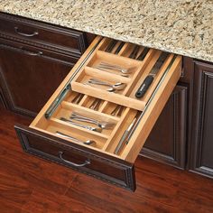 an open drawer with utensils in it