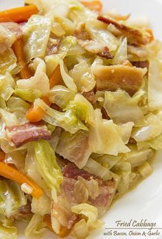 a white plate topped with cabbage and carrots