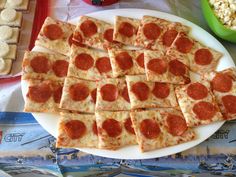 pizza slices are arranged on a plate next to bowls of rice and other food items