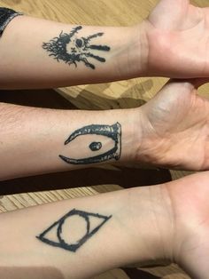 two people with matching tattoos on their arms and wrist, one has an eye in the middle