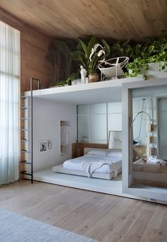 there is a bed that has plants on top of it and in the middle of the room