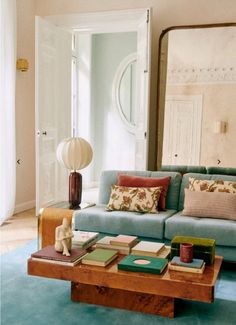 a living room with a blue couch and coffee table in it's center area