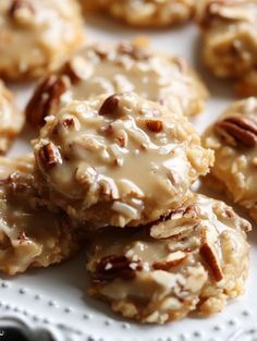 pecan cookies with icing and nuts on a white plate